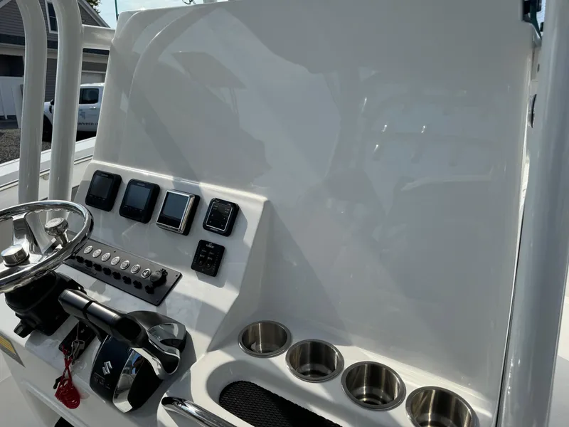 Slide: The Image of Control panel of 2025 Cape Horn 32 XS boat with steering wheel and cup holders. - 11