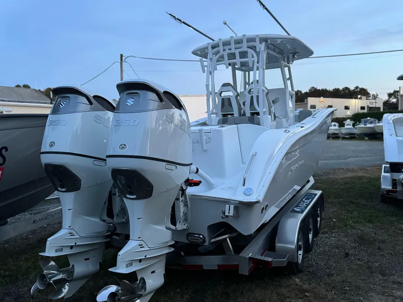 Slide: The Image of 2025 Cape Horn 32 XS boat with dual outboard engines on a trailer. - 12