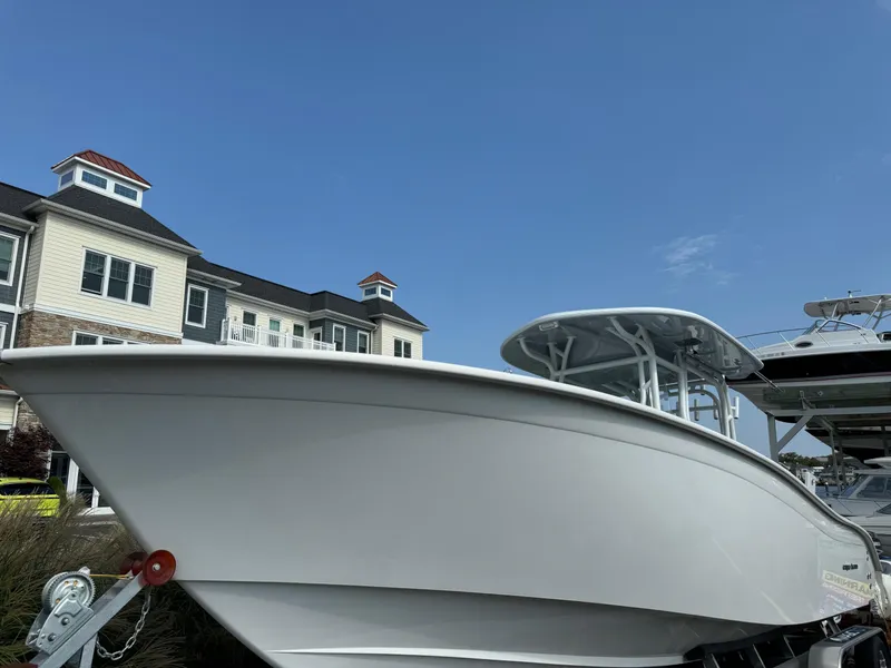 Slide: The Image of 2025 Cape Horn 32 XS boat displayed outdoors near buildings under clear blue sky. - 9