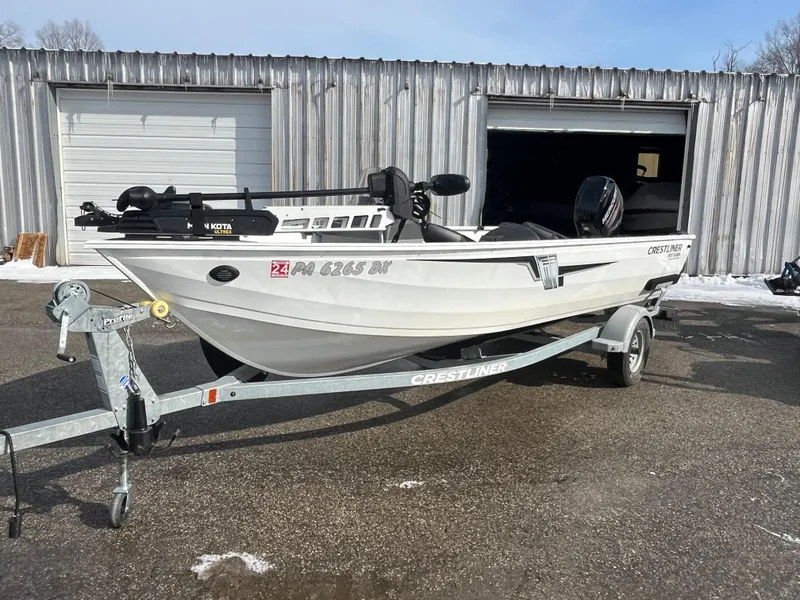 Slide: The Image of 2020 Crestliner 1800 Kodiak SC boat on trailer, parked outside metal building. - 10