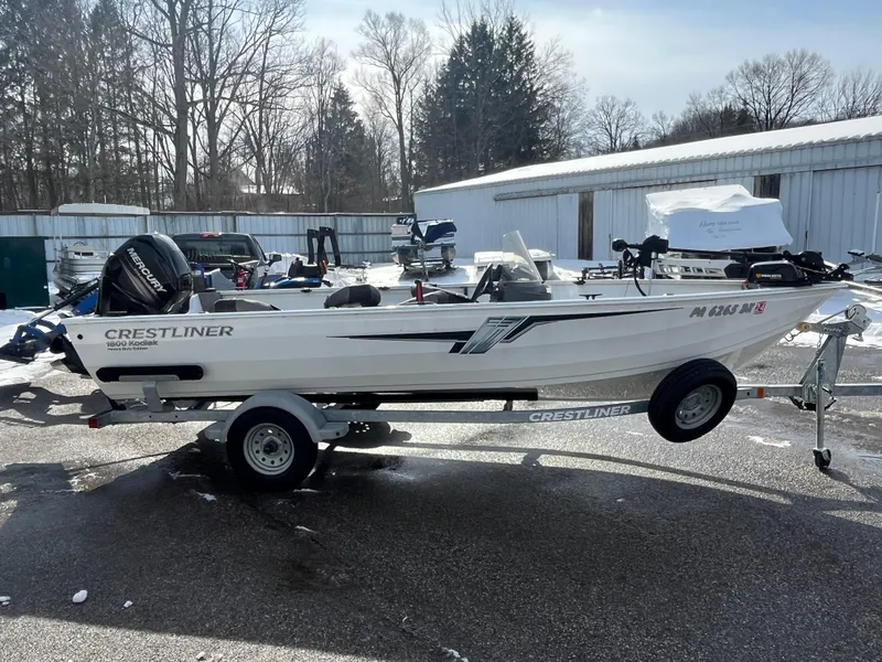 Slide: The Image of 2020 Crestliner 1800 Kodiak SC boat on trailer, parked outdoors in winter setting. - 12