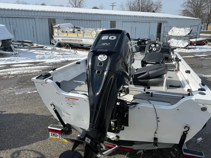 Slide: The Image of 2020 Crestliner 1800 Kodiak SC boat with 60 HP outboard motor in snowy setting. - 2