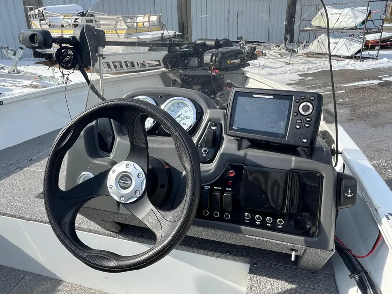 Slide: The Image of Crestliner 1800 Kodiak SC 2020 boat dashboard with steering wheel and navigation system. - 3