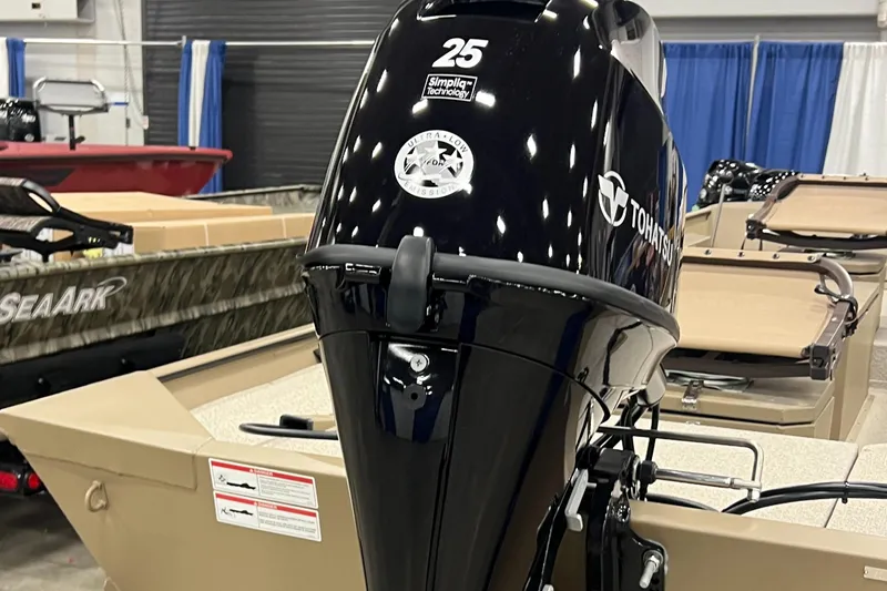 Slide: The Image of 2025 SeaArk 1652 Crappie boat with Tohatsu 25 HP outboard motor displayed indoors. - 13