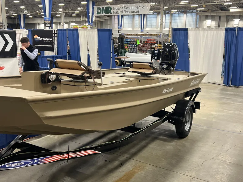 The Image of 2025 SeaArk 1652 Crappie boat displayed indoors on a trailer. - 0