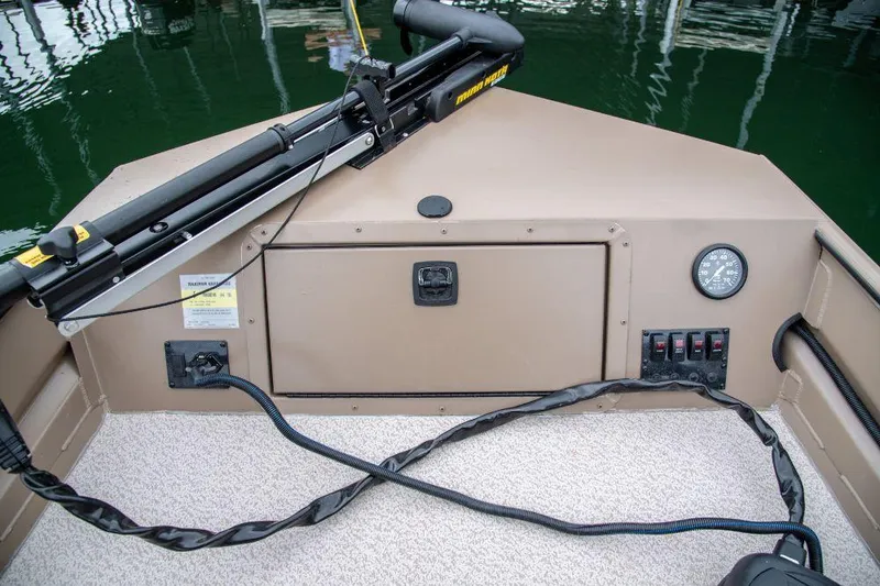 Slide: The Image of 2025 SeaArk 1652 Crappie boat with spacious deck and storage compartments. - 2