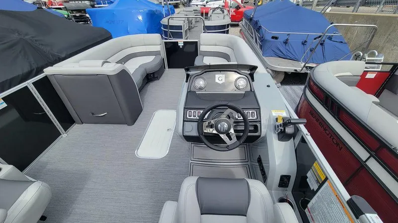 Slide: The Image of 2025 Godfrey Monaco 235 DFL pontoon boat interior with modern helm and spacious seating. - 11