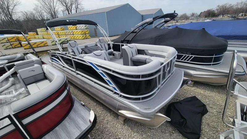 Slide: The Image of 2025 Godfrey Monaco 235 DFL pontoon boat with iMPACT Center Tube Package, docked outdoors. - 12