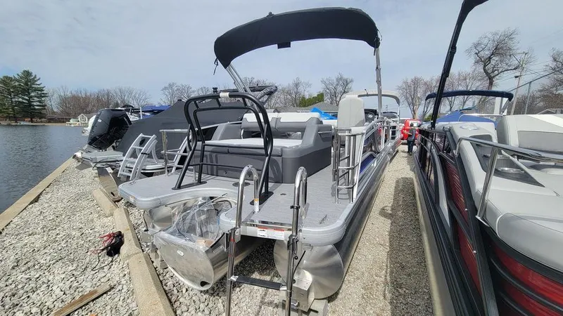 Slide: The Image of 2025 Godfrey Monaco 235 DFL pontoon boat docked, featuring iMPACT Center Tube Package. - 13