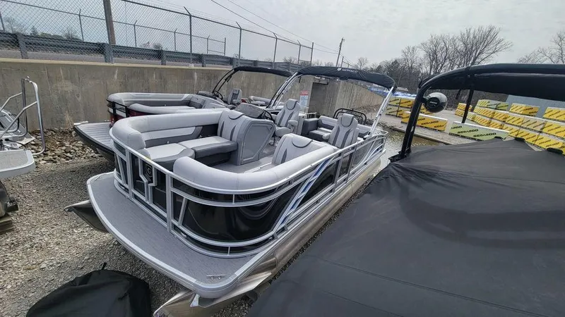 Slide: The Image of 2025 Godfrey Monaco 235 DFL pontoon boat with iMPACT Center Tube Package, docked outdoors. - 5