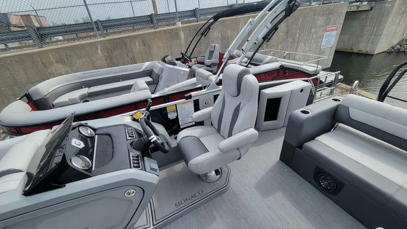 Slide: The Image of 2025 Godfrey Monaco 235 DFL pontoon boat interior with modern seating and control console. - 9