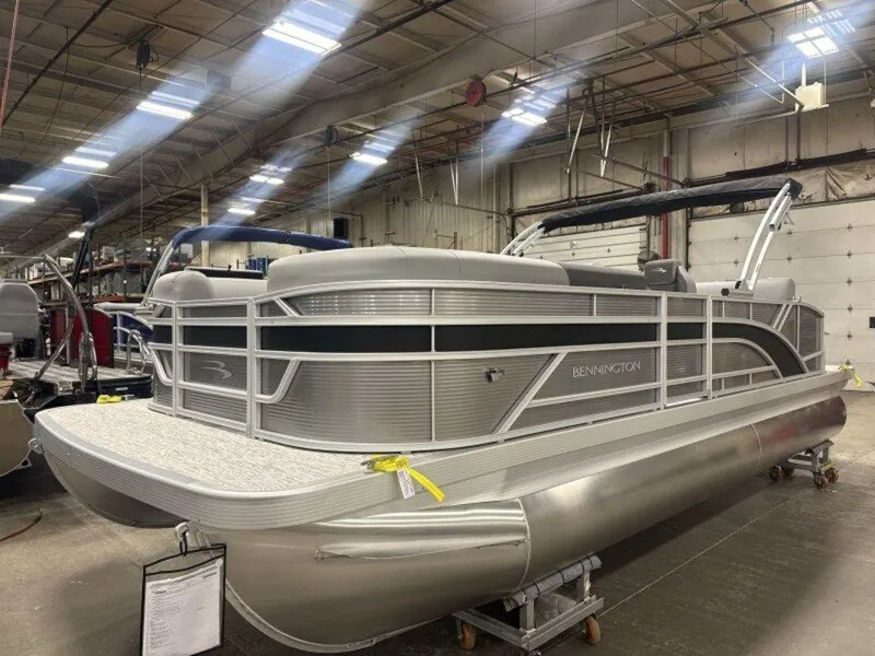 Slide: The Image of 2025 Bennington S Swingback 22 SSB pontoon boat in a warehouse setting. - 10