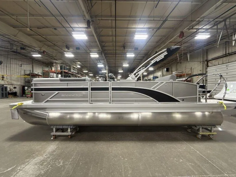 Slide: The Image of 2025 Bennington S Swingback 22 SSB pontoon boat in a warehouse setting. - 11
