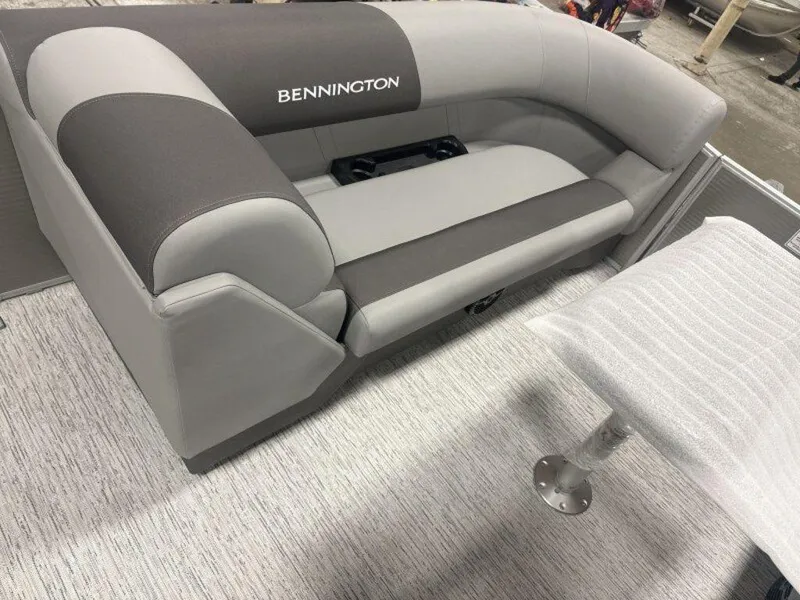 Slide: The Image of 2025 Bennington S Swingback 22 SSB boat seating, featuring gray and black upholstery. - 12
