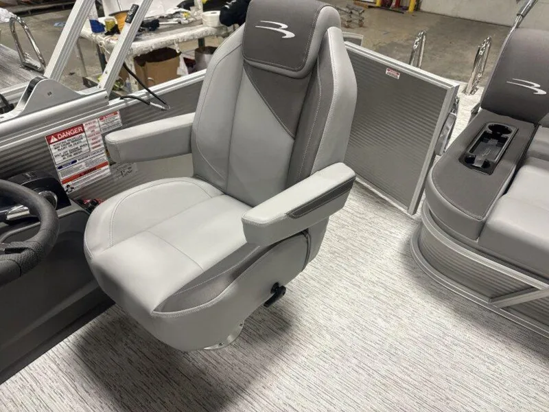 Slide: The Image of 2025 Bennington S Swingback 22 SSB boat interior with gray captain's chair and sleek design. - 15