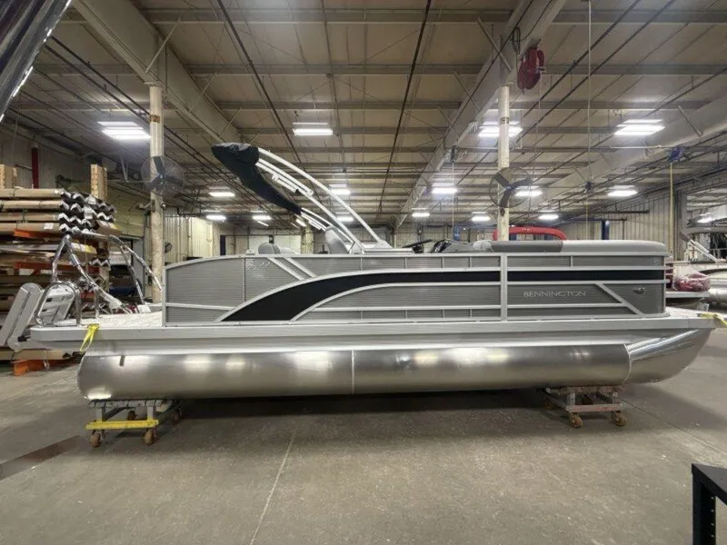Slide: The Image of 2025 Bennington S Swingback 22 SSB pontoon boat in a warehouse setting. - 22