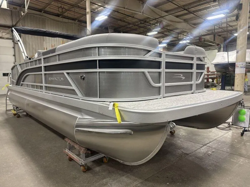 Slide: The Image of 2025 Bennington S Swingback 22 SSB pontoon boat in a warehouse setting. - 23