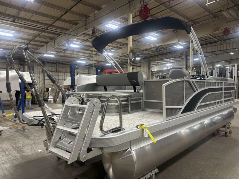 Slide: The Image of 2025 Bennington S Swingback 22 SSB pontoon boat in a warehouse setting. - 24
