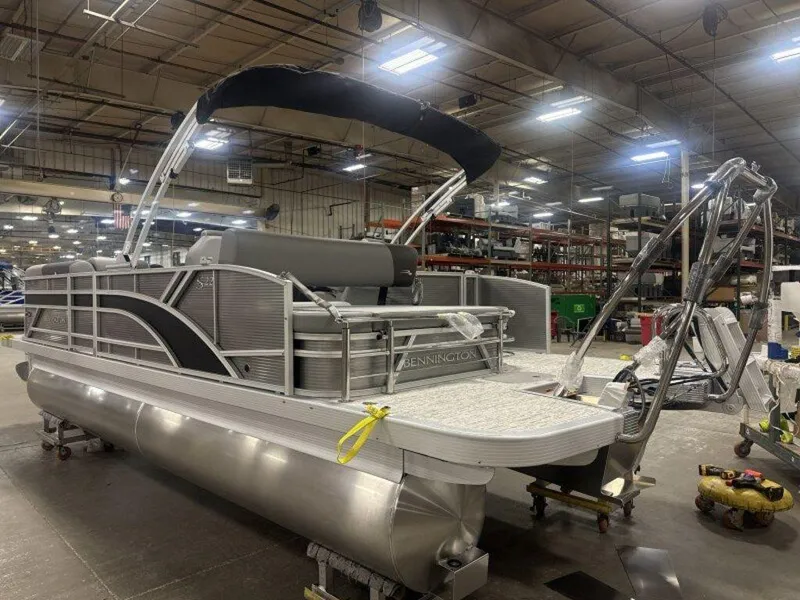 Slide: The Image of 2025 Bennington S Swingback 22 SSB pontoon boat in a warehouse setting. - 25