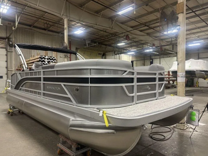 Slide: The Image of 2025 Bennington S Swingback 22 SSB pontoon boat in a warehouse setting. - 9