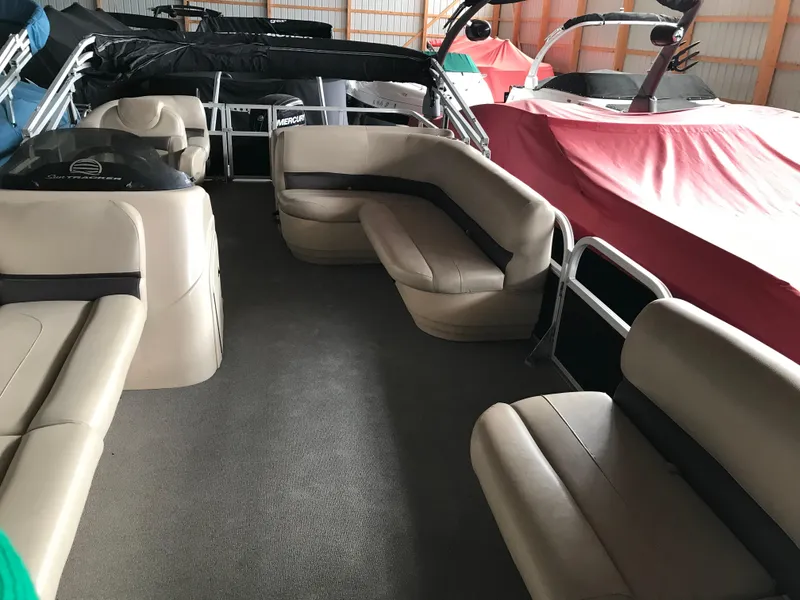 Slide: The Image of 2017 Sun Tracker Party Barge 22 DLX interior with beige seating and spacious layout. - 4