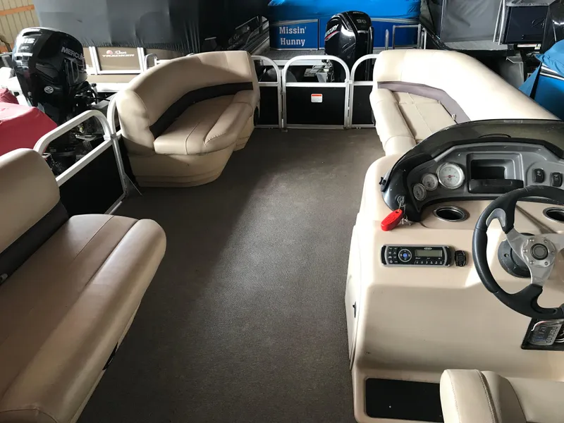 Slide: The Image of 2017 Sun Tracker Party Barge 22 DLX interior with seating and control console. - 6