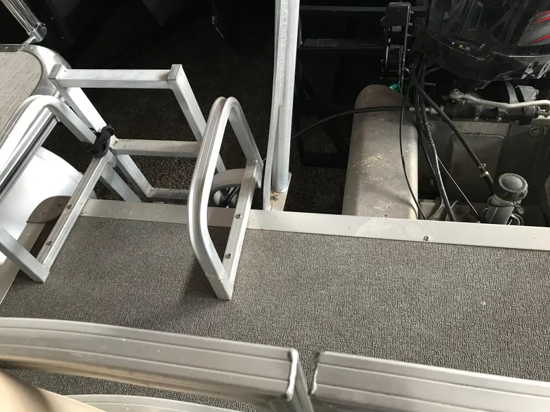 Slide: The Image of 2017 Sun Tracker Party Barge 22 DLX deck with ladder and engine components. - 9