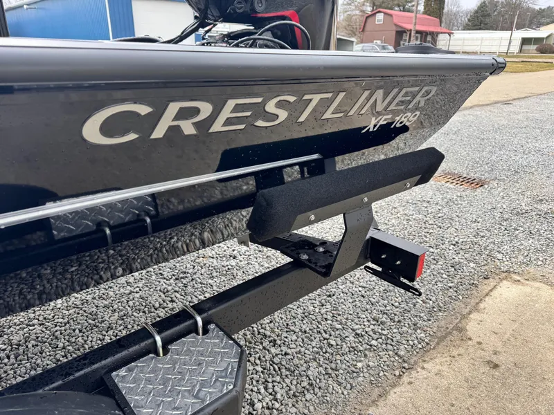 Slide: The Image of 2025 Crestliner XF189 boat on trailer, close-up view of branding and hull. - 11