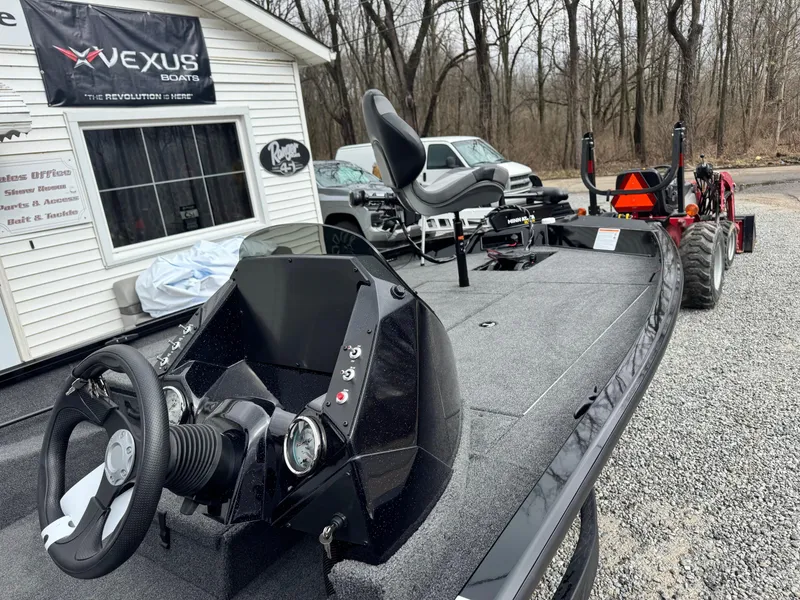 Slide: The Image of 2025 Crestliner XF189 fishing boat with steering console, parked near a dealership. - 6
