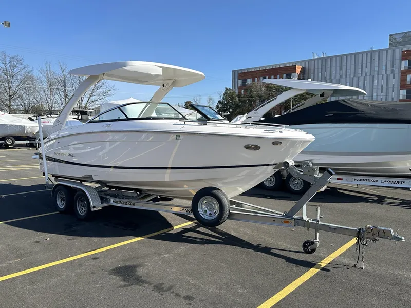Slide: The Image of 2022 Regal LX4 boat on trailer in parking lot, sunny day. - 2