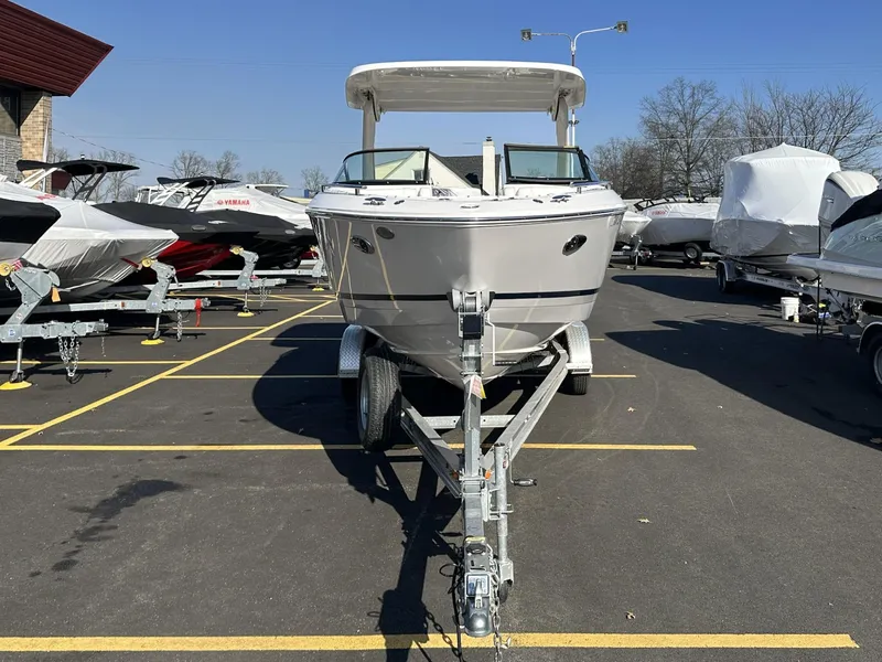 Slide: The Image of 2022 Regal LX4 boat on trailer in parking lot, surrounded by other boats. - 3