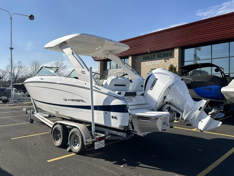 Slide: The Image of 2022 Regal LX4 boat on trailer at Holly Acres Marine dealership. - 4