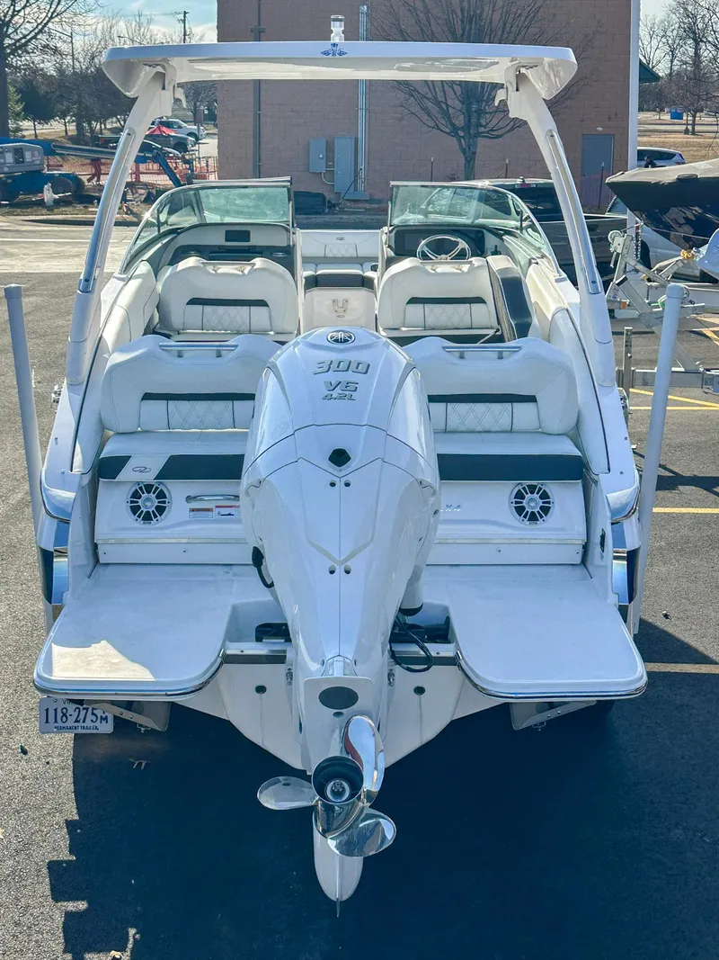 Slide: The Image of 2022 Regal LX4 boat with outboard motor, rear view in a parking lot. - 5
