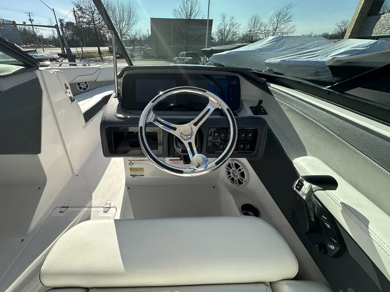 Slide: The Image of 2022 Regal LX4 boat cockpit with modern steering wheel and dashboard controls. - 7