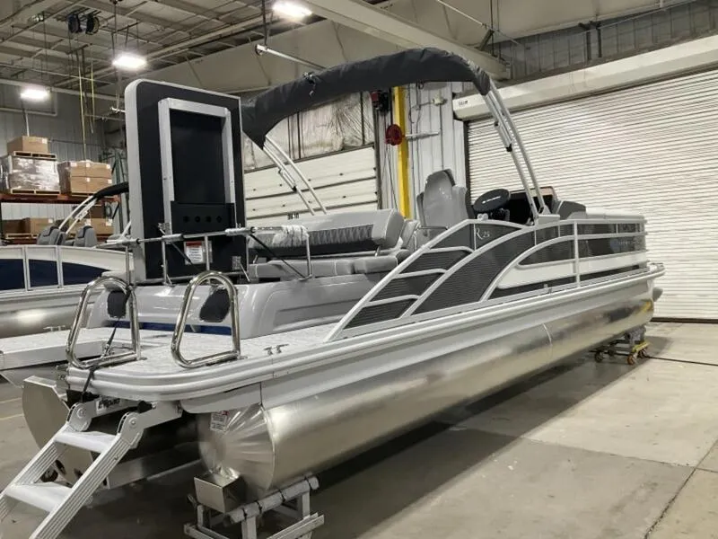 Slide: The Image of 2025 Bennington R Swingback 25 RSB pontoon boat in a warehouse setting. - 10