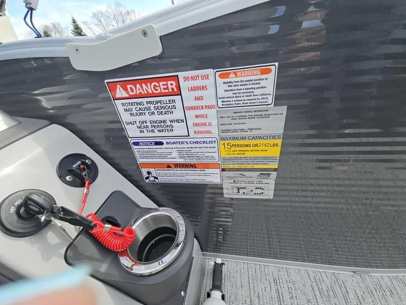 Slide: The Image of 2025 Bennington R Swingback 25 RSB boat safety warnings and capacity labels. - 8