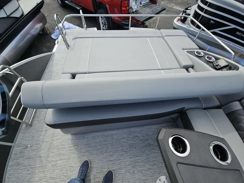 Slide: The Image of 2025 Bennington R Swingback 25 RSB boat interior with gray seating and cup holders. - 9
