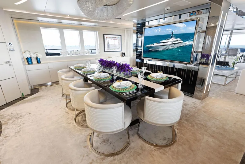 Slide: The Image of Luxurious dining area on 2019 Bilgin 156 yacht with elegant decor and large screen. - 13