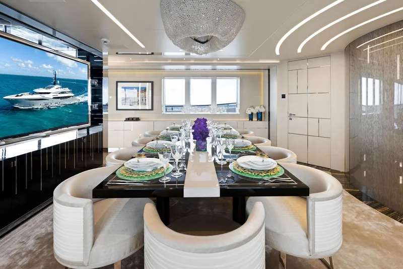 Slide: The Image of Luxurious dining area on Bilgin 156 yacht, featuring elegant table setting and modern decor. - 14