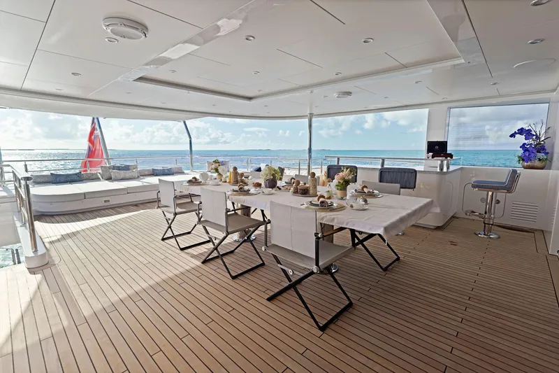 Slide: The Image of Luxurious Bilgin 156 yacht deck with elegant dining setup, ocean view, and modern design. - 37