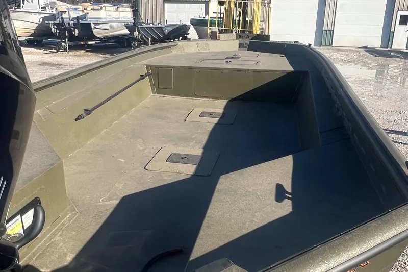 Slide: The Image of 2025 SeaArk 1960 Slayer Pro boat interior, featuring spacious deck and storage compartments. - 7