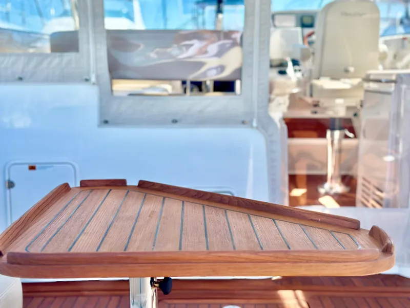 Slide: The Image of 2007 Chris-Craft Roamer 40 yacht interior with wooden table and seating area. - 15