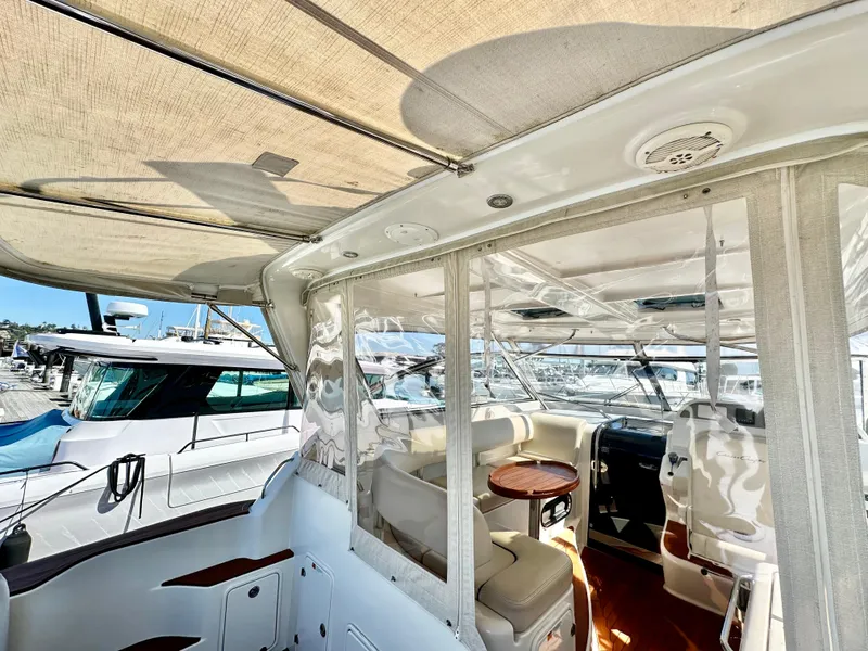 Slide: The Image of 2007 Chris-Craft Roamer 40 yacht interior with seating and helm, docked at marina. - 16