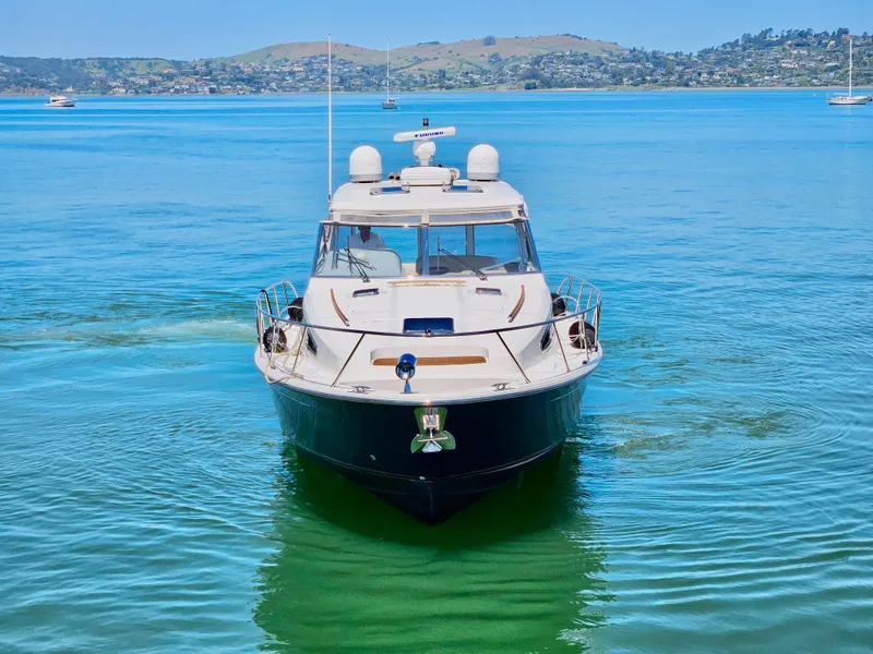 Slide: The Image of 2007 Chris-Craft Roamer 40 yacht on serene blue water, distant hills in background. - 2