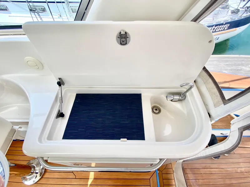 Slide: The Image of 2007 Chris-Craft Roamer 40 yacht sink with open lid, showcasing sleek design and functionality. - 22