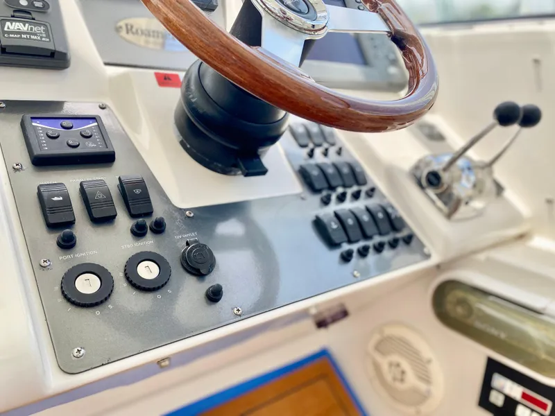 Slide: The Image of Control panel of a 2007 Chris-Craft Roamer 40 yacht with wooden steering wheel. - 25