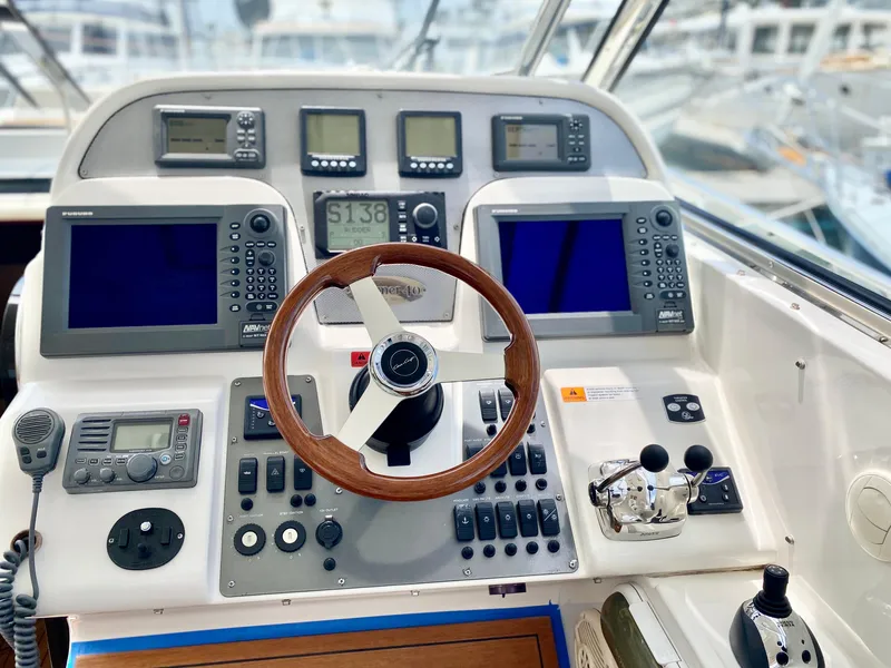 Slide: The Image of 2007 Chris-Craft Roamer 40 helm with advanced navigation controls and wooden steering wheel. - 27