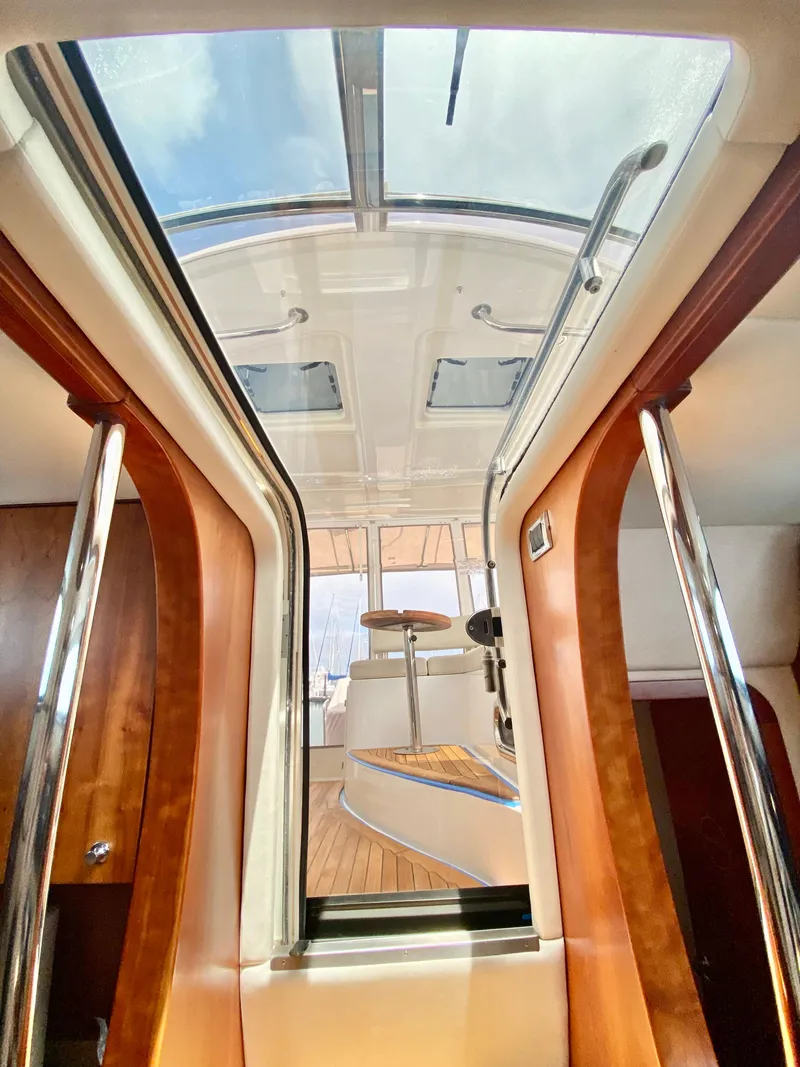 Slide: The Image of Interior view of 2007 Chris-Craft Roamer 40 yacht with skylight and polished wood finishes. - 34