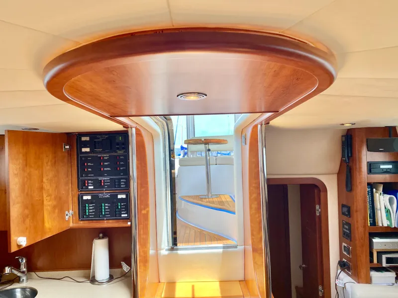 Slide: The Image of Interior view of 2007 Chris-Craft Roamer 40 yacht, featuring wood paneling and control panels. - 36