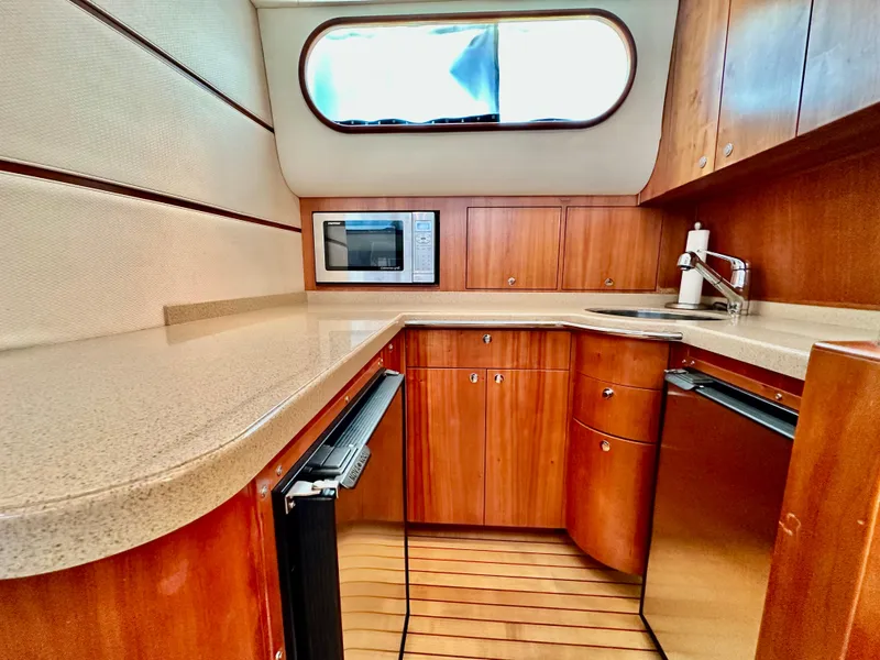 Slide: The Image of Luxurious 2007 Chris-Craft Roamer 40 yacht kitchen with wood cabinetry and modern appliances. - 37